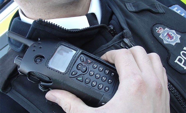 A policeman holding a radio