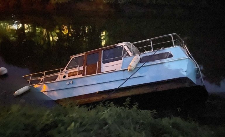 Boats partially submerged after water level in River Avon drops dramatically