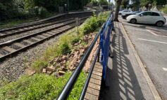 Railway disruption after car crashes through railings at station